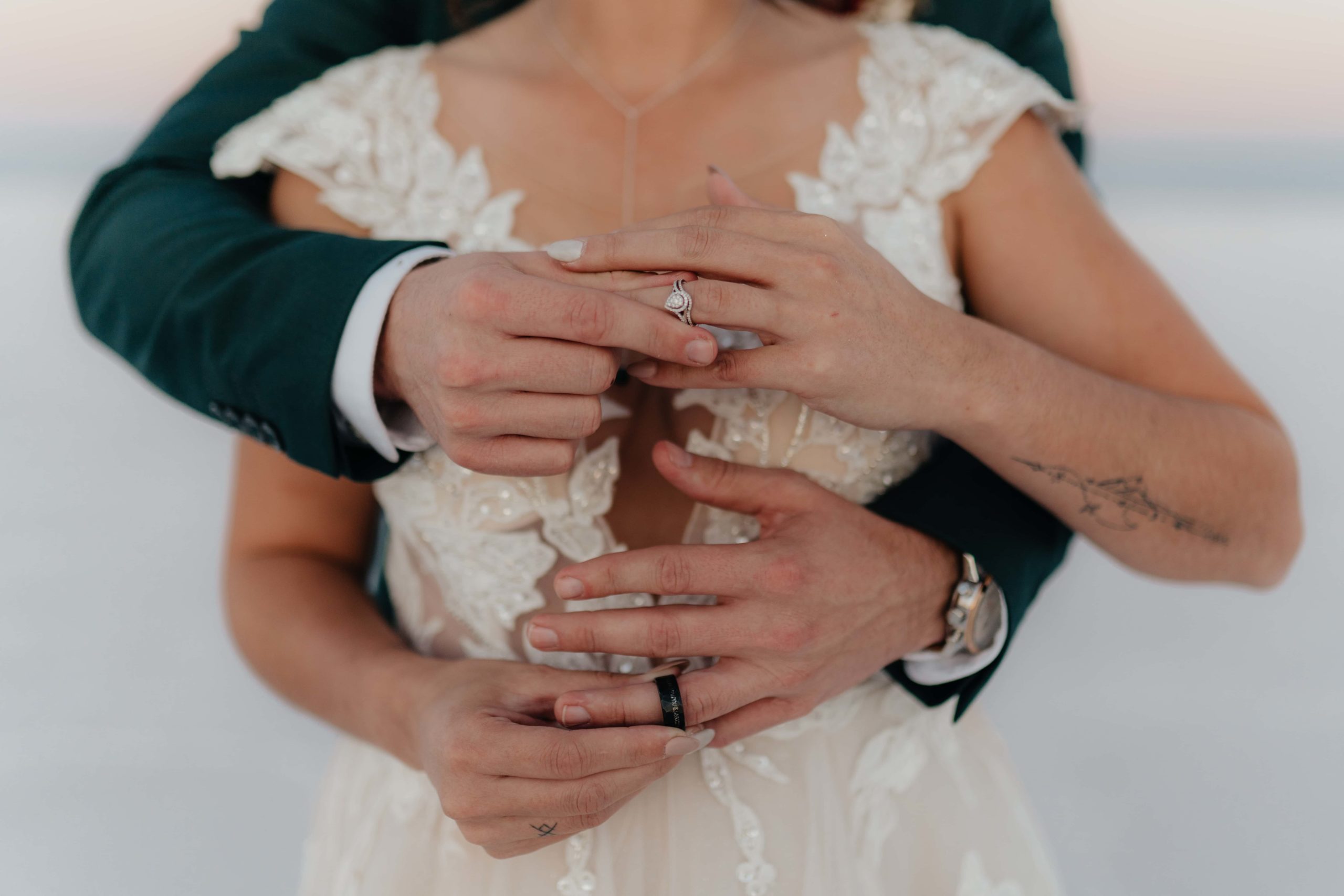 Couple puts rings on each others' fingers during their salt flats elopement